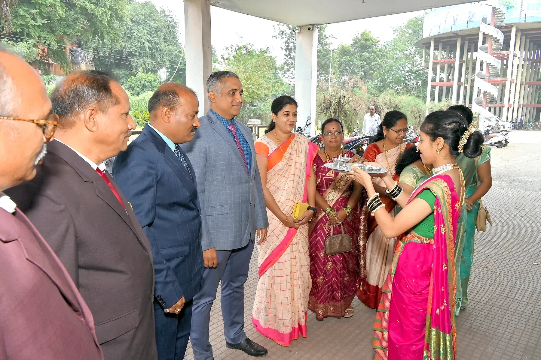 Guests being welcomed with a traditional aarti tray on arrival at a college event