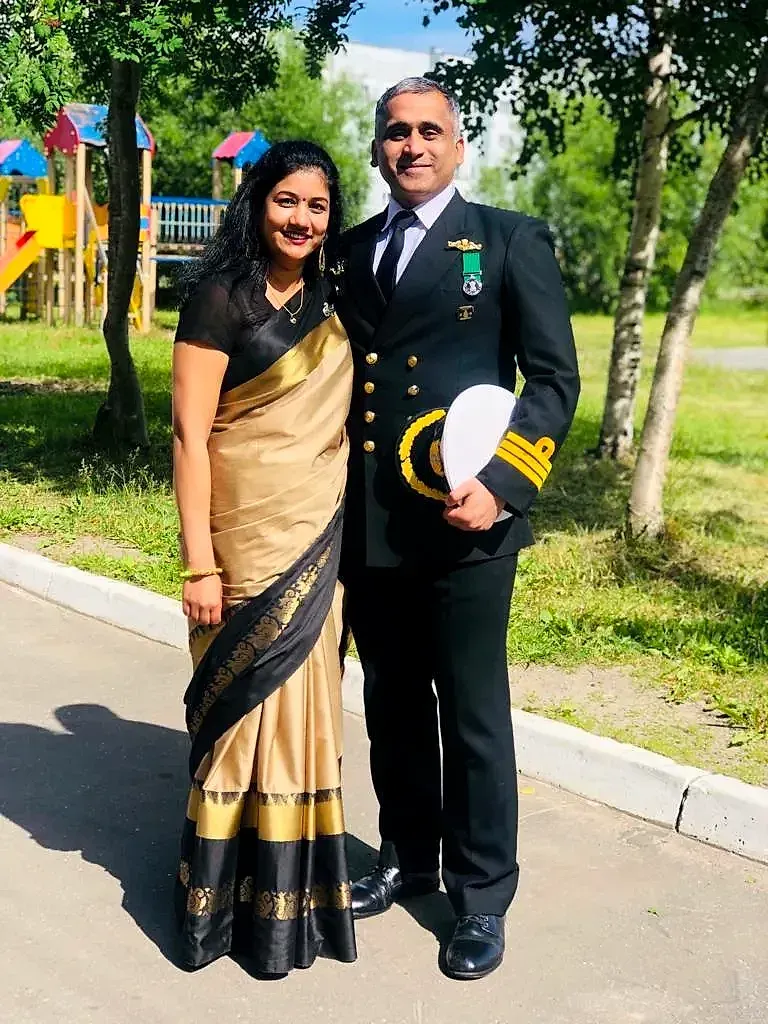 Captain Khochare in dress blues beside Ashwini Khochare in a gold and black saree