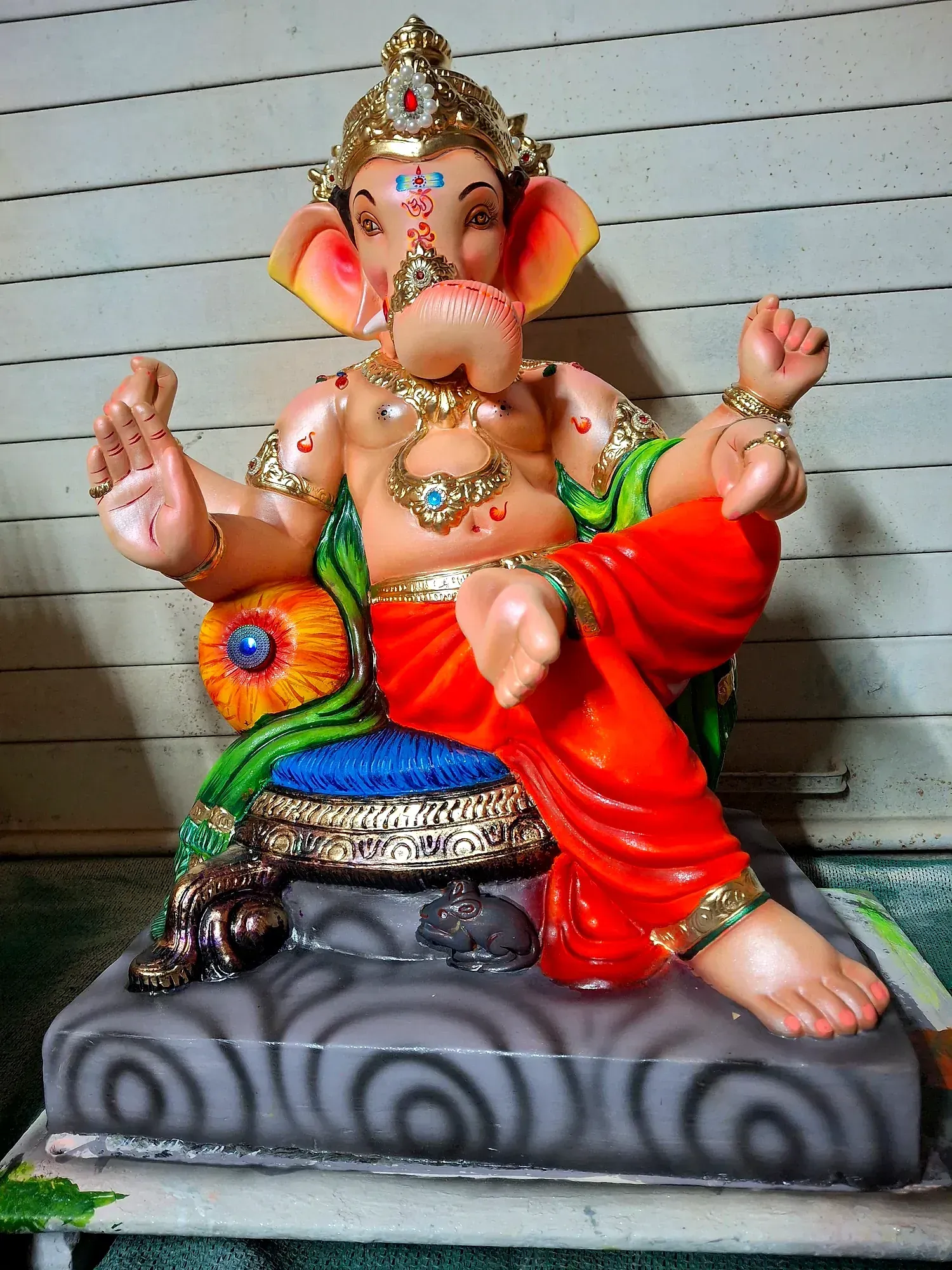 A brightly painted Ganesh idol finished and ready for packing