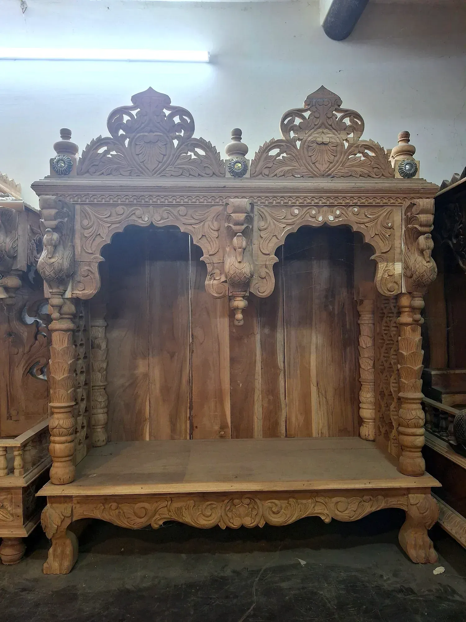 An intricately carved teak wood temple shrine